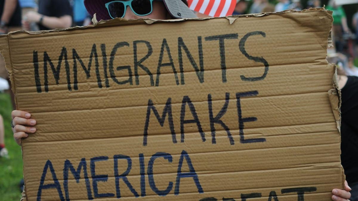 Close-up of sign reading 'Immigrants Make America Great' at a Baltimore rally.