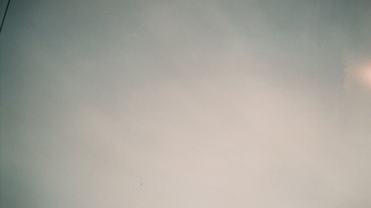 A serene view of a clear sky with soft clouds, perfect for background or design work.