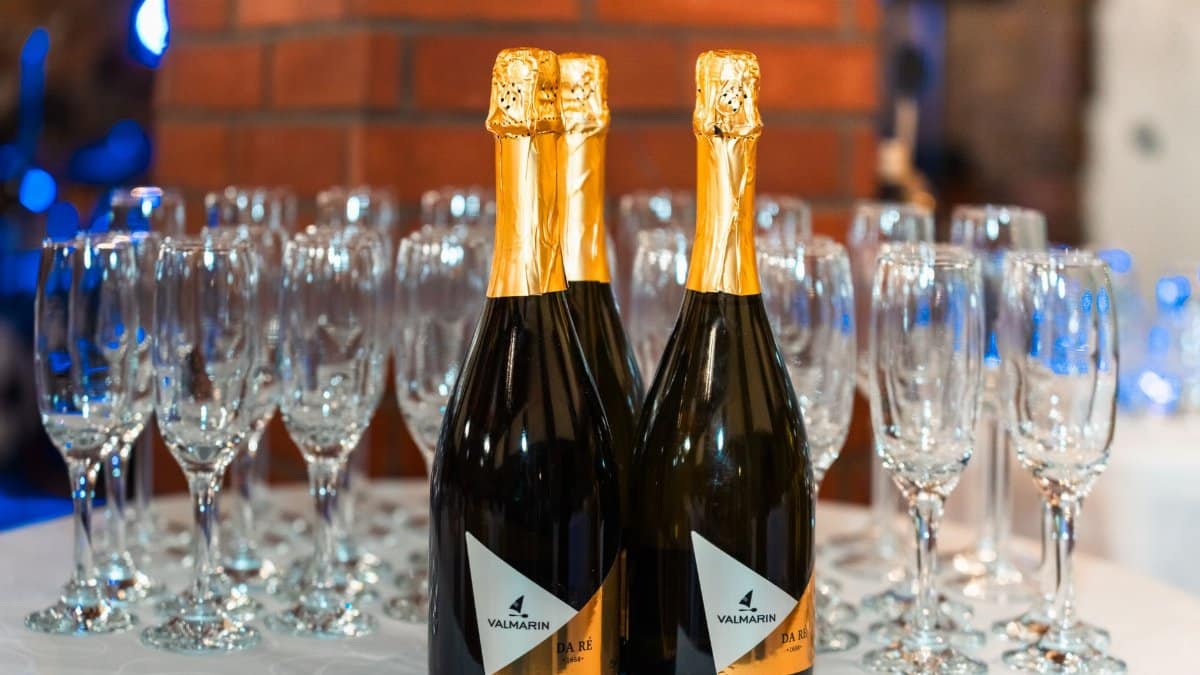 Champagne bottles with empty flutes on a table, set for a celebration or event.