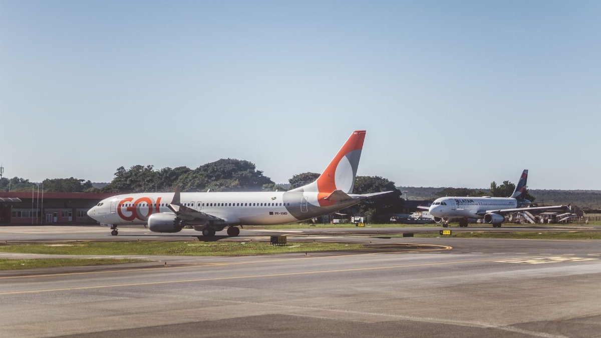 Airliners taxiing on a sunny day at an airport, ready for takeoff.