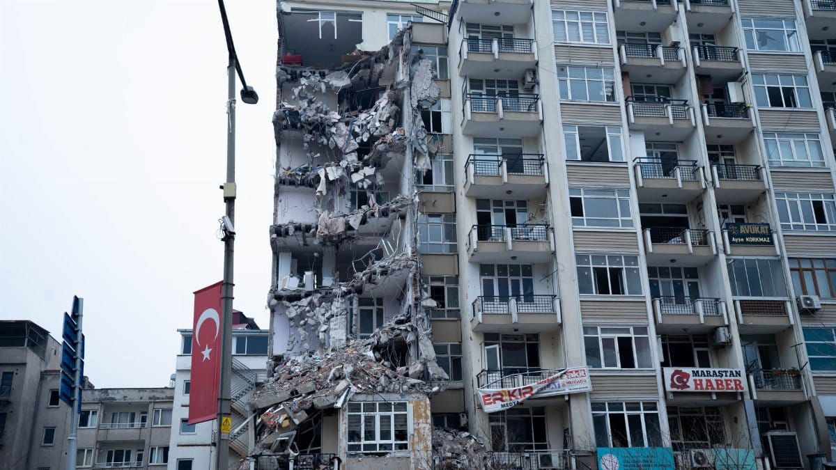 Collapsed residential building after earthquake in Turkey, showcasing severe structural damage.