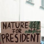 Sign at a climate protest advocating for environmental priorities with text 'Nature for President.'