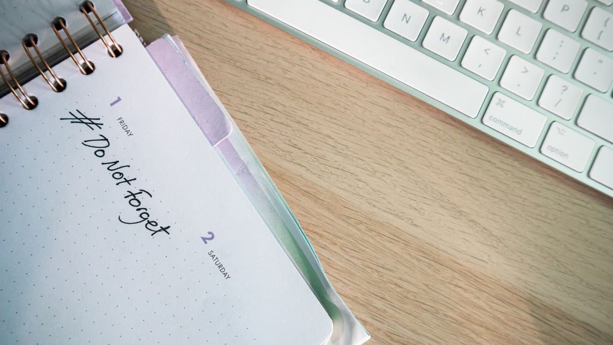 A close-up shot of a planner and keyboard on a desk, showcasing organization.