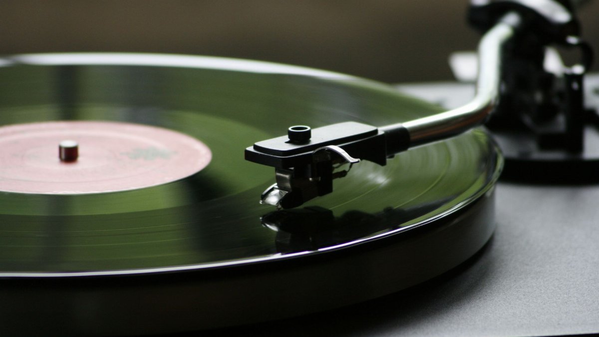 A close-up view of a rotating vinyl record on a vintage turntable player.