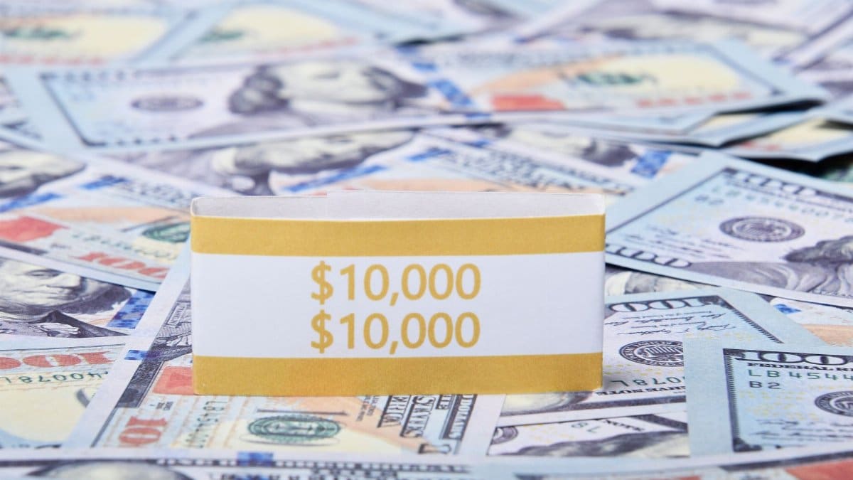 Close-up of US dollar banknotes with a $10,000 money band, ideal for finance and investment themes.