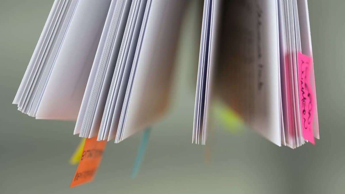 A close-up view of book pages with colorful sticky tabs, suggesting organization or study.