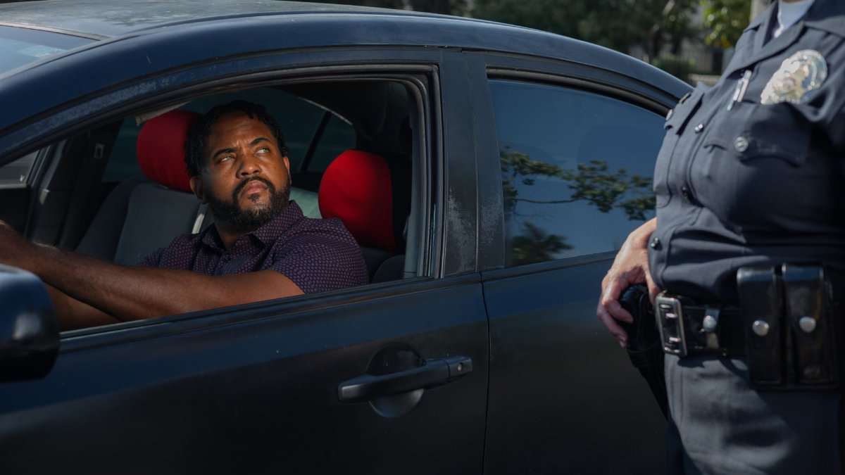 A driver receives a traffic ticket from a police officer for a speeding violation.
