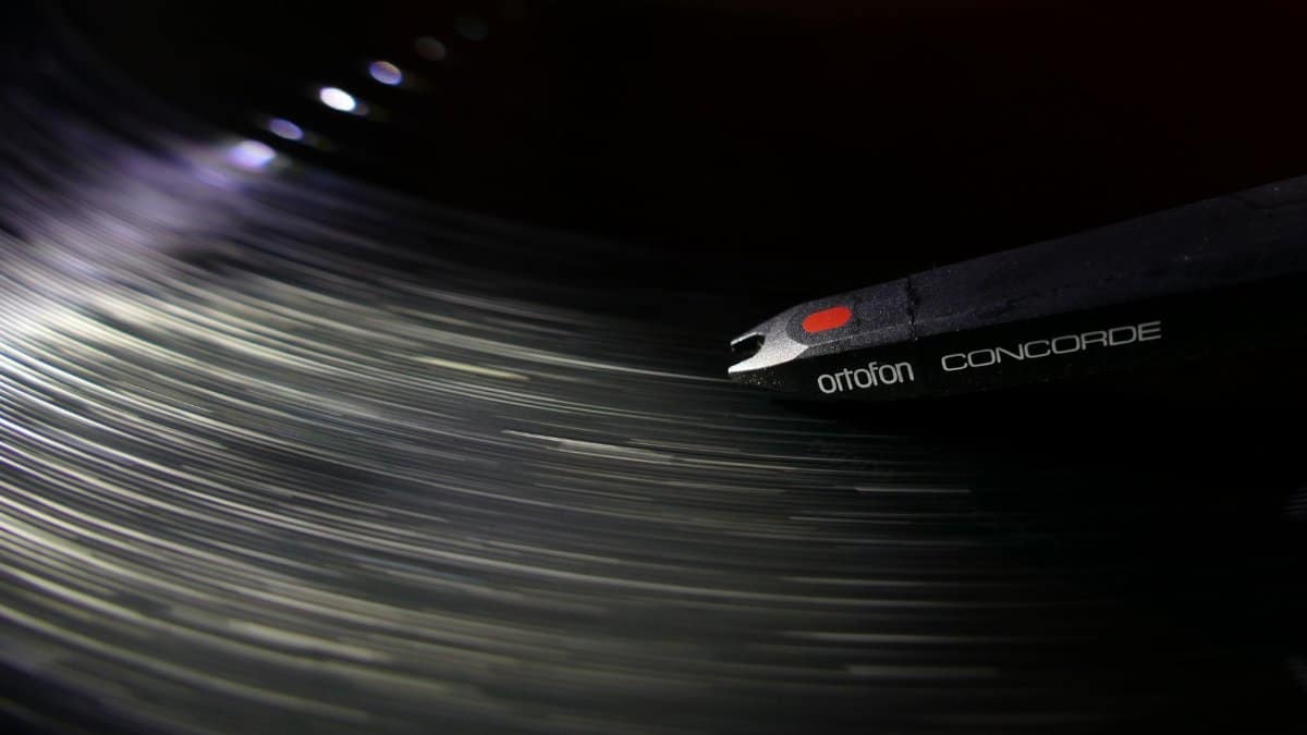 Dynamic close-up of an Ortofon Concorde needle playing a vinyl record, capturing the motion and vibe of music.