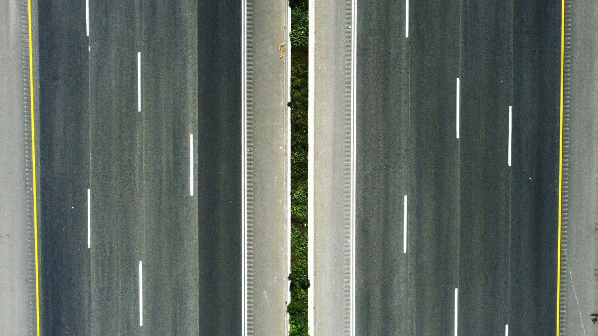 Top-down aerial view of a highway with green median in Petach Tikva, Israel.
