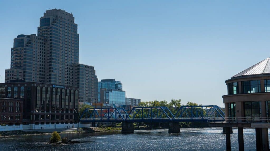 Scenic view of Grand Rapids featuring the iconic Blue Bridge and modern skyline buildings.