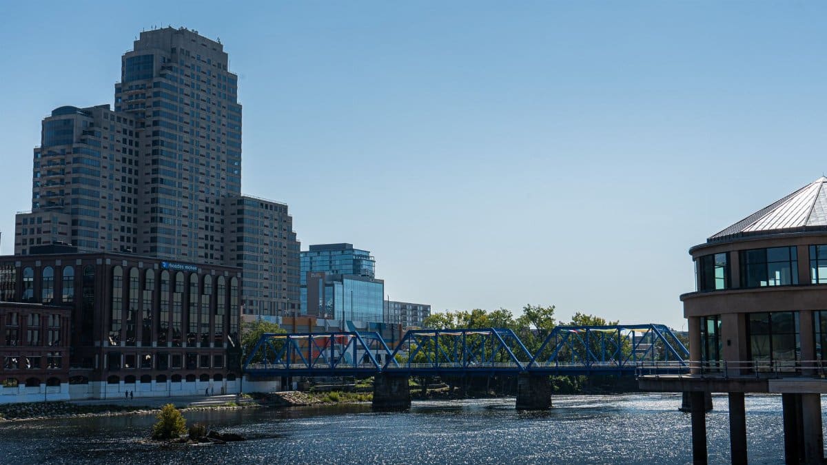 Scenic view of Grand Rapids featuring the iconic Blue Bridge and modern skyline buildings.