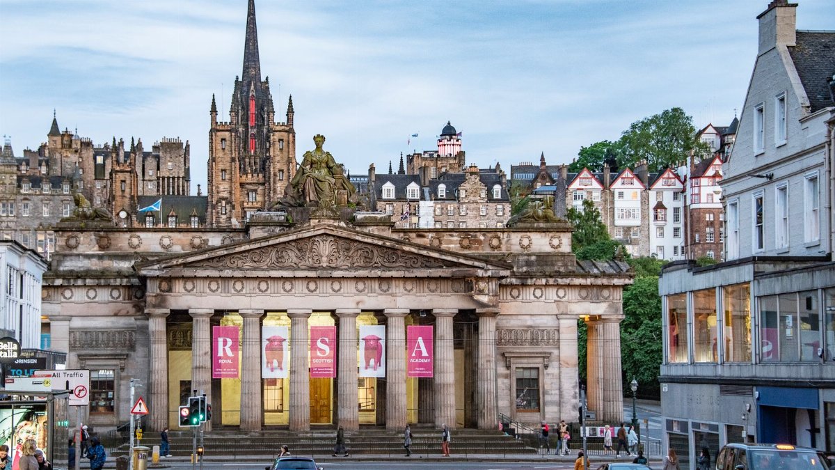 A stunning view of the National Galleries of Scotland in Edinburgh with a bustling city street.