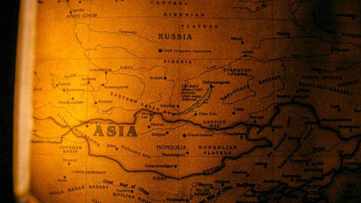 Detailed vintage map showcasing Asia with focus on Russia and Mongolia in warm tones.