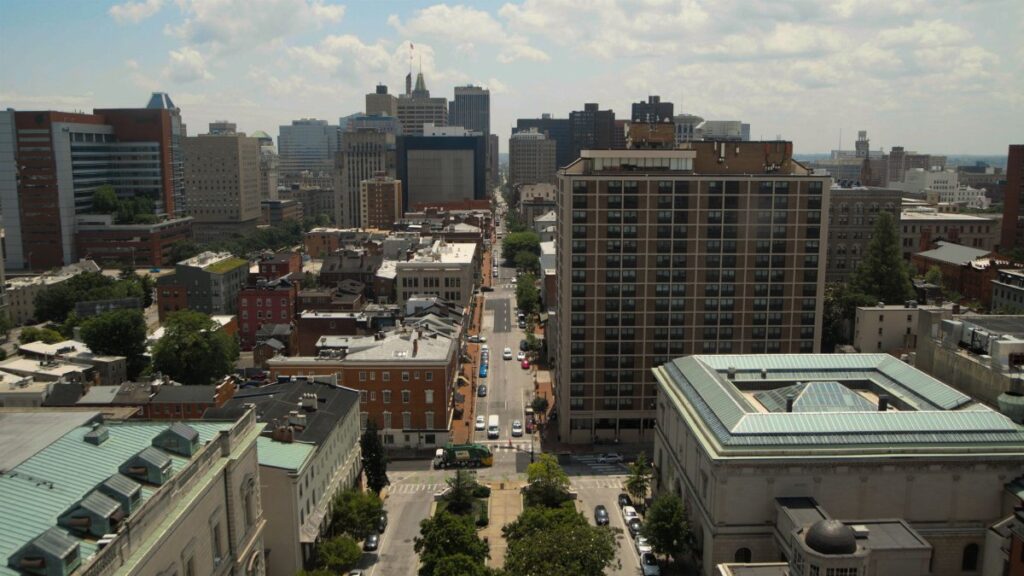 Panoramic aerial view of downtown Baltimore's skyline featuring skyscrapers and residential buildings.