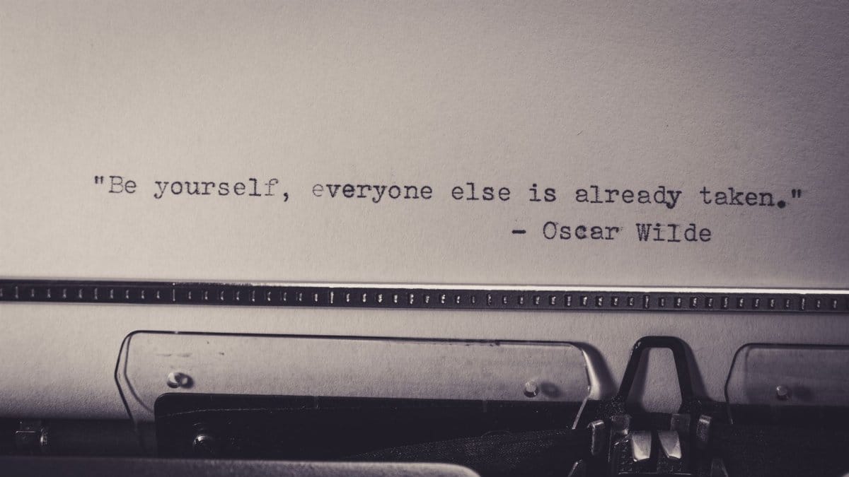 Vintage typewriter displaying Oscar Wilde's quote 'Be yourself, everyone else is already taken.'