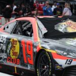 Close-up of a NASCAR race car in the paddock area during a racetrack event.