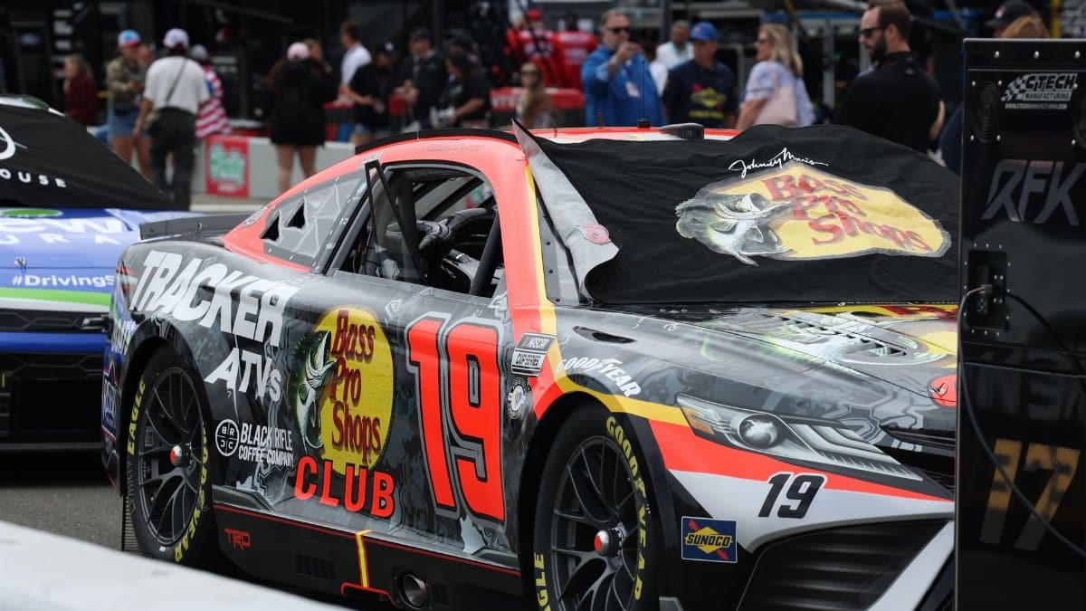 Close-up of a NASCAR race car in the paddock area during a racetrack event.