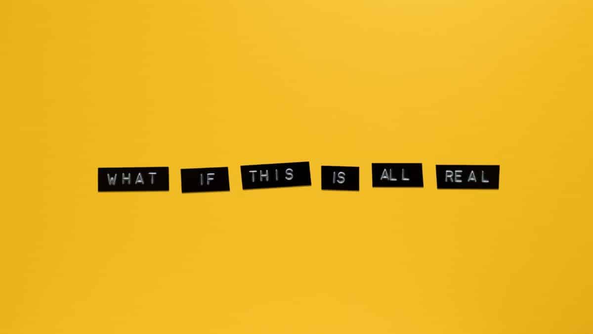 Minimalist text on vibrant yellow backdrop reading 'What if this is all real.'
