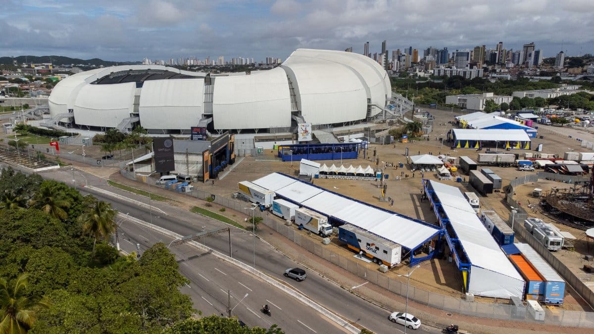 Aerial shot of Arena das Dunas stadium located in Natal, Rio Grande do Norte, Brazil with cityscape in background.