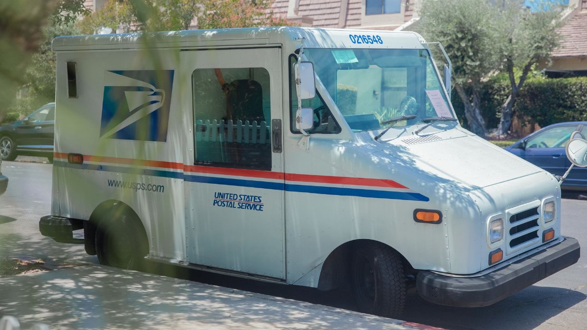 United States Postal Service van parked on a sunny street in Los Angeles, CA.