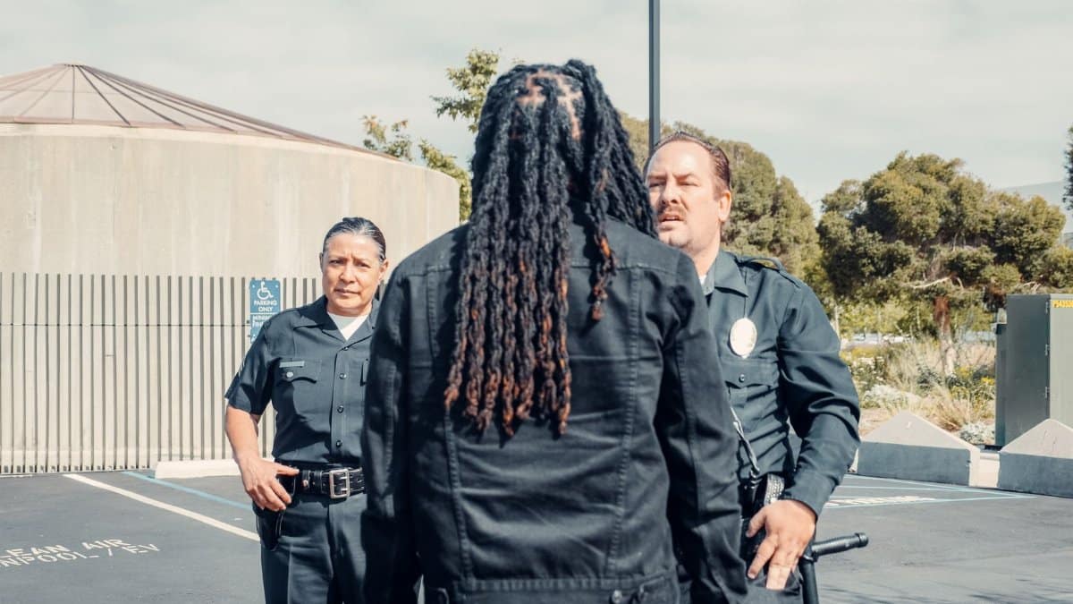 Two police officers engage in discussion outside, focusing on community interactions.