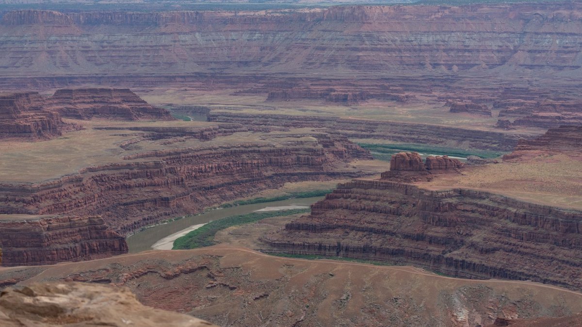 A breathtaking aerial view of Dead Horse Point State Park, showcasing layered canyons and the Colorado River.