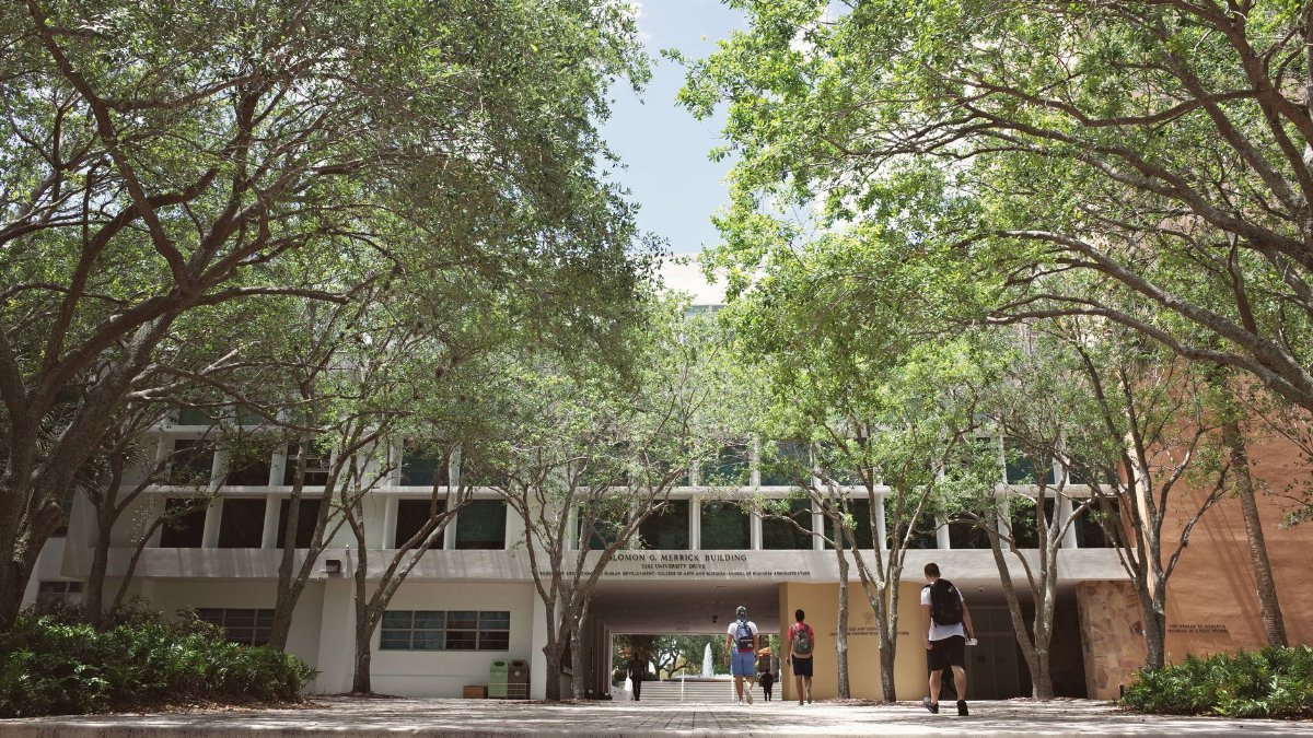 University campus in Coral Gables, Florida, with students walking under a sunny sky.