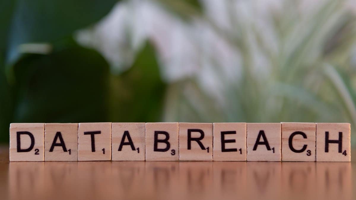 Close-up of Scrabble tiles spelling 'data breach' on a blurred background