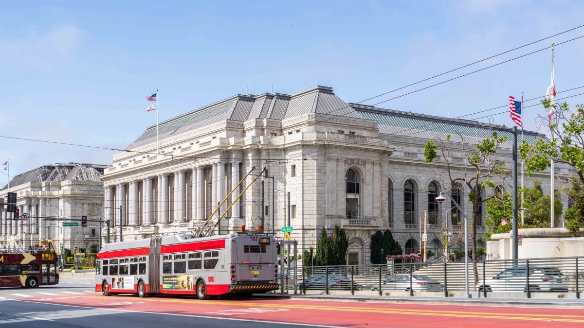 Classic architecture of Civic Center with trolley bus in San Francisco.