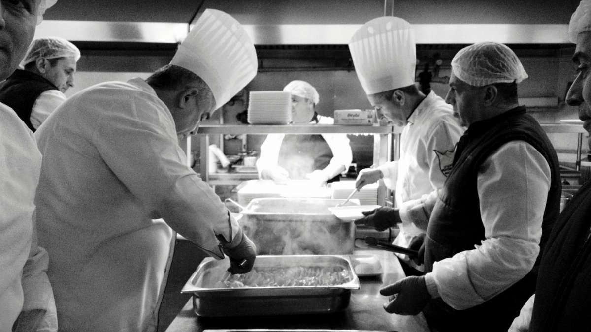 Chefs at work in a bustling kitchen in Istanbul, creating culinary magic in black and white.