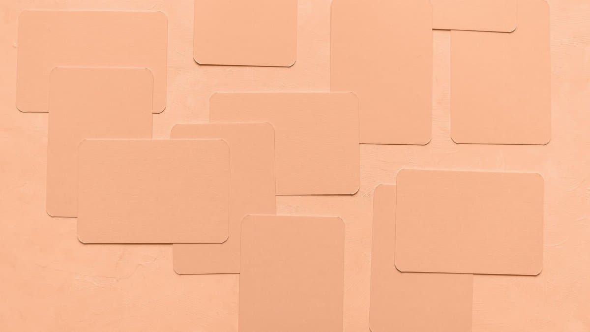 Artistic composition of overlapping peach-colored cards on a matching background.