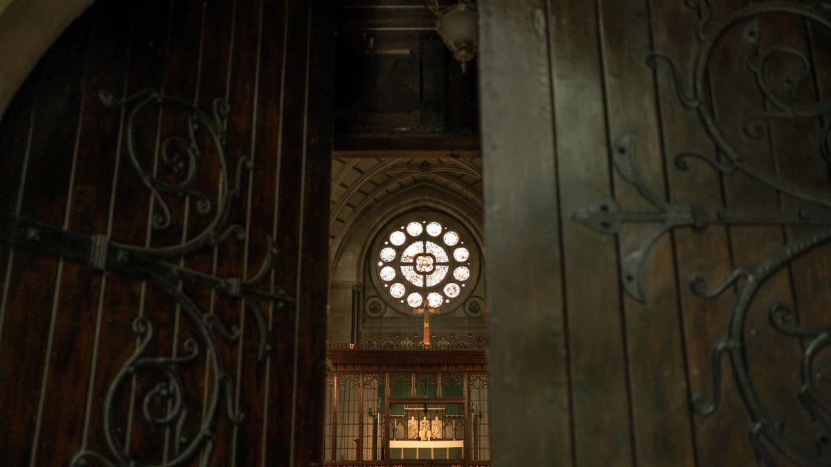 A low-angle view through open church doors, revealing a beautifully ornamented interior.