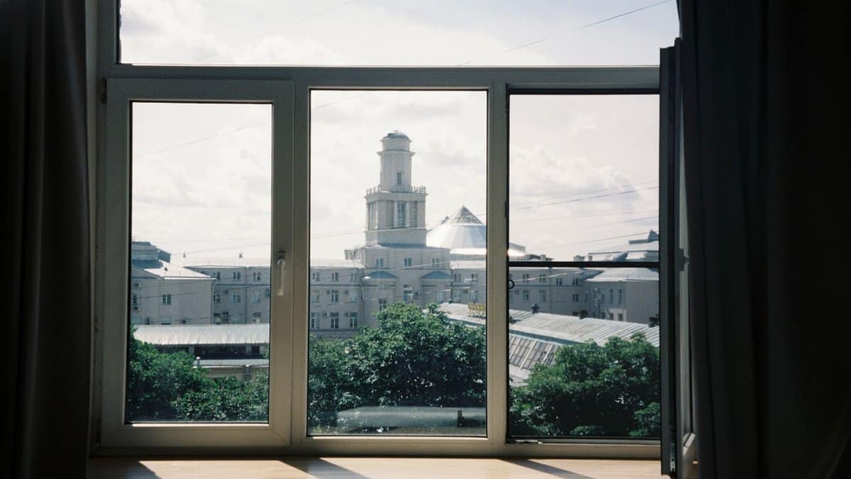 Captivating view of a city's architectural landmark through an open window.