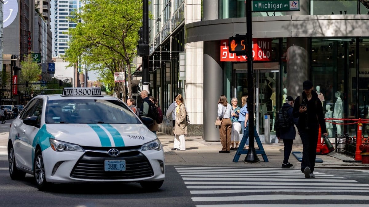 Dynamic street view of Chicago with a taxi and pedestrians at Michigan Avenue.
