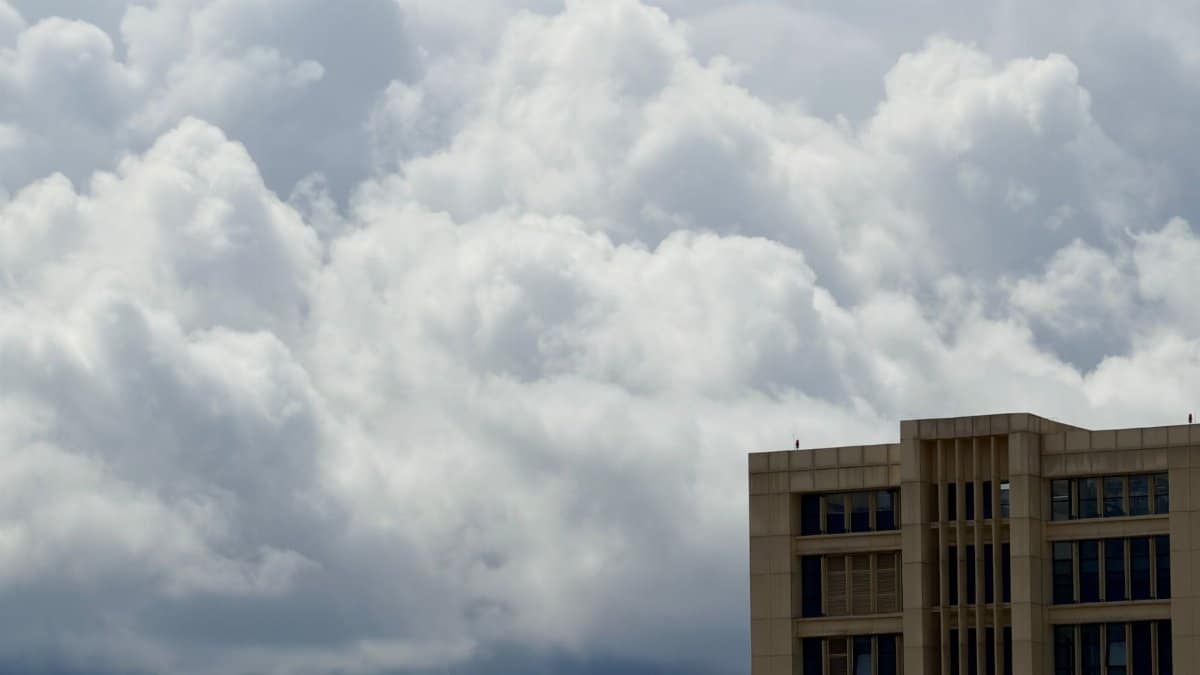 Modern building with dramatic clouds, capturing the essence of urban architecture and weather contrast.