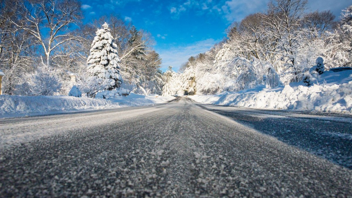 A serene snow-covered road surrounded by winter trees in Southborough, Massachusetts.