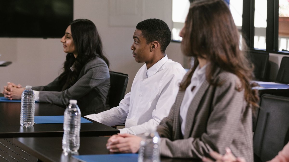 Diverse professionals attending a meeting in a modern conference room.