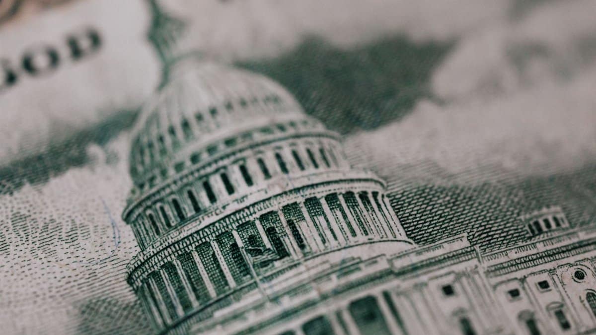 From above of photo of historic Capitol of USA Congress in neoclassical style with columns and dome represented on paper money