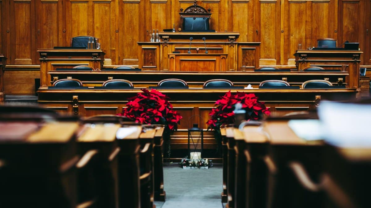 Spacious and elegant wooden courtroom with empty seats, located in Bern, Switzerland.