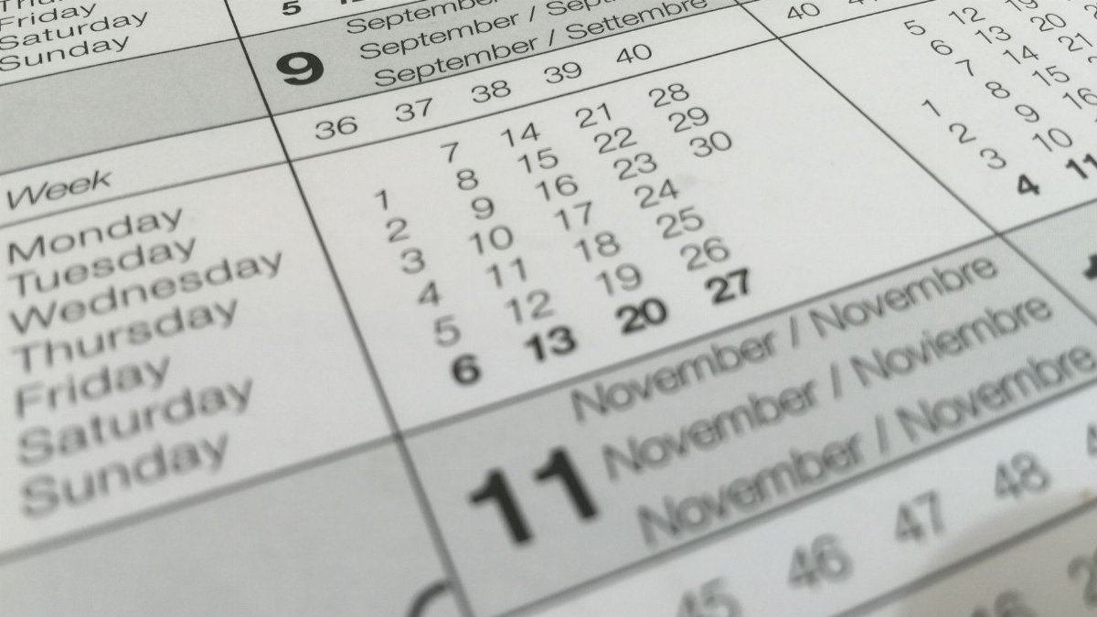 Detailed close-up of a calendar displaying months in several languages.