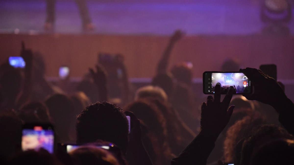 Audience capturing live music performance with phones at night concert in San Luis, Argentina.