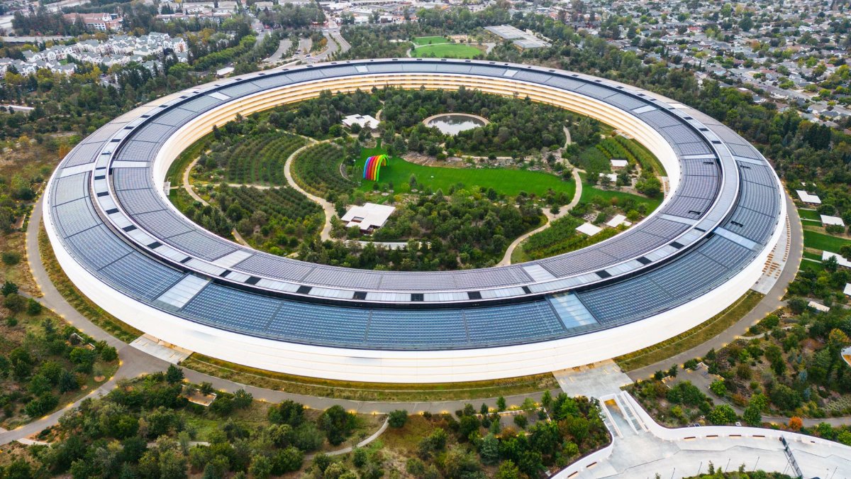 Stunning aerial view of the modern Apple Park in Cupertino, showcasing its unique circular design and lush greenery.