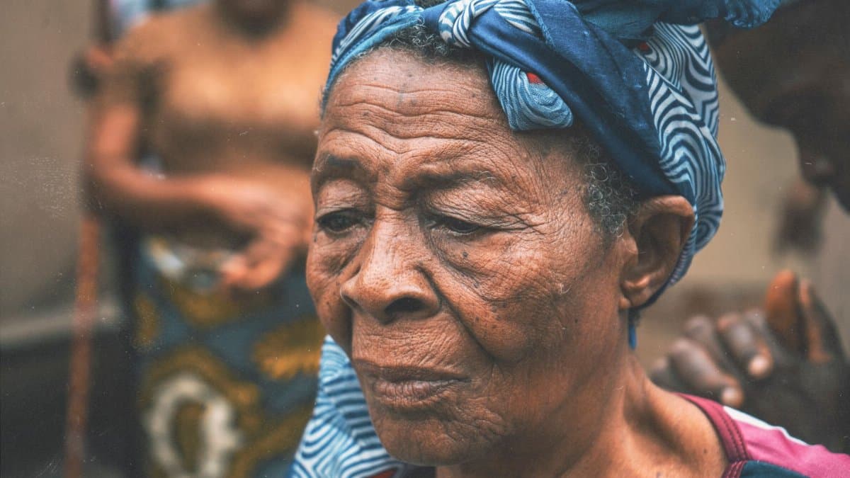 Close-up portrait of an elderly woman wearing a traditional headscarf, showcasing cultural attire.