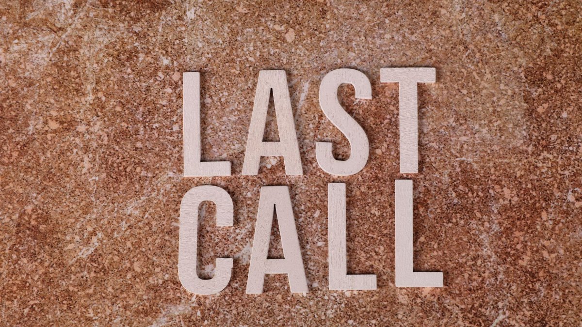A top view of wooden letters spelling 'Last Call' on a textured brown surface.