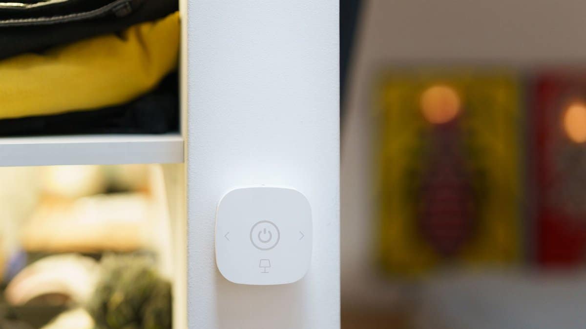 Close-up of a smart home light switch in a modern room interior, showcasing contemporary technology.