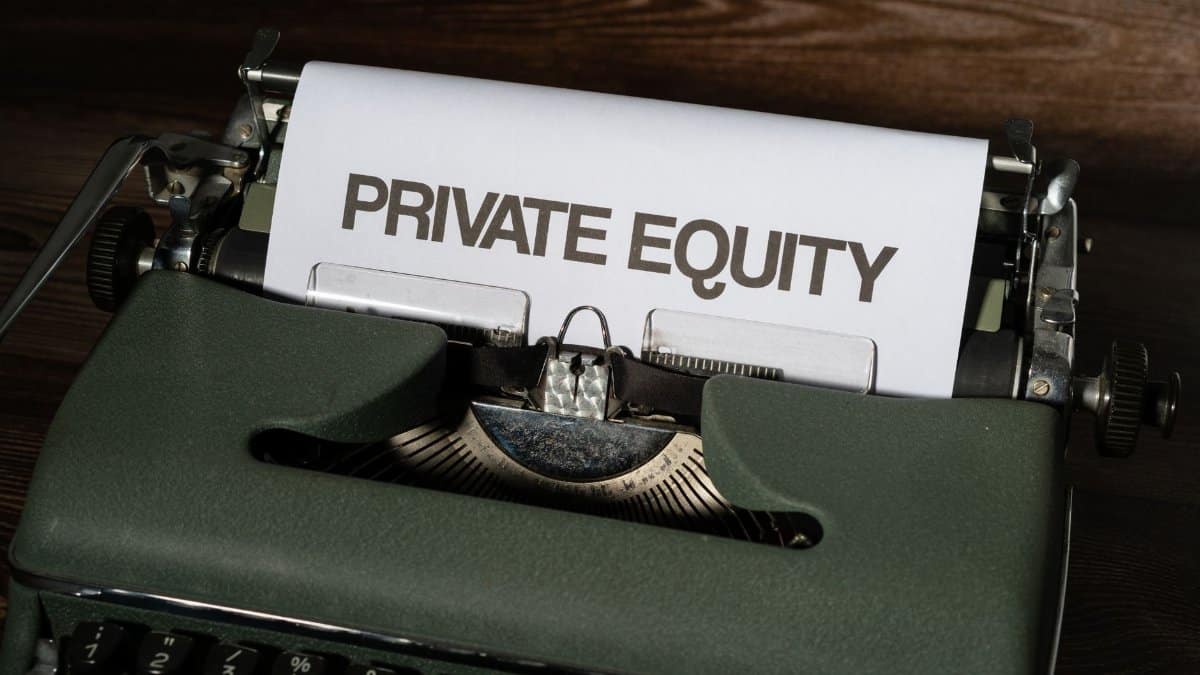 Close-up of a vintage typewriter with paper displaying 'Private Equity'.