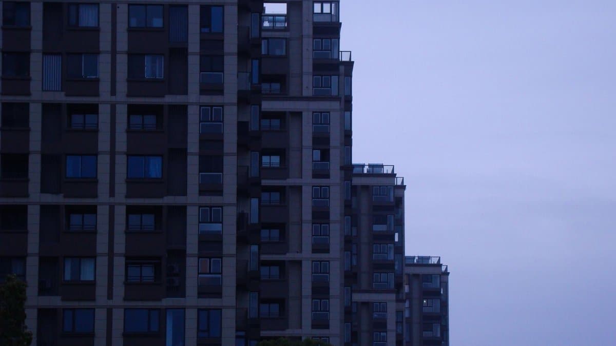 A contemporary skyscraper in a cityscape at dusk showcasing modern architectural design.