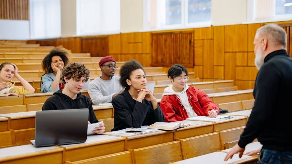 Students from diverse backgrounds engaged in a university lecture setting.