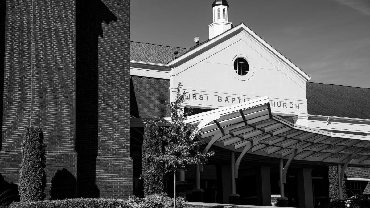 Black and white image of the First Baptist Church in Trussville, showcasing classic architecture.