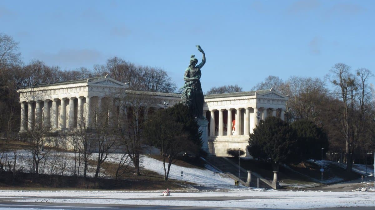 Bavaria statue with Hall of Fame in snowy Theresienwiese, Munich captured on a winter day.